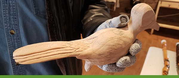 An in-progress artwork of a roadrunner carved from wood.