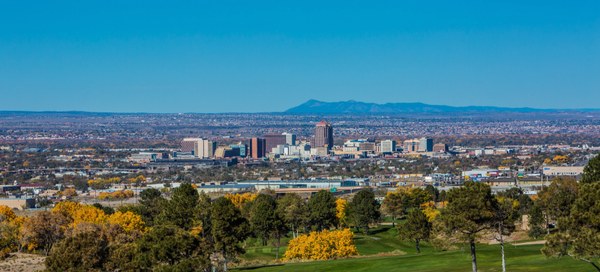 Albuquerque in the Fall The City of Albuquerque seen from a grass field with trees changing color for the fall.