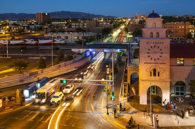 Downtown Alvarado transit center in the evening. Rail Runner and mountains in the background.